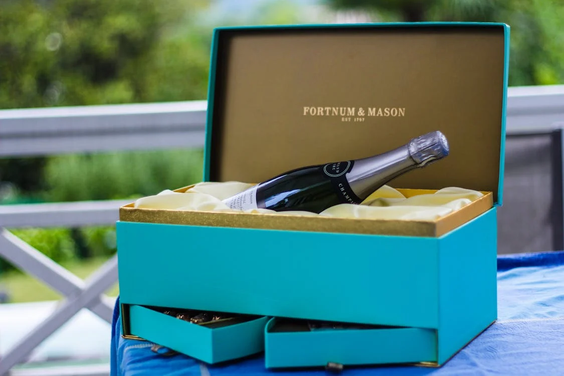 Fortnum and Mason blue gift box with drawers with bottle of champagne inside 