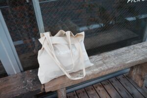 cream tote bag on a wooden bench