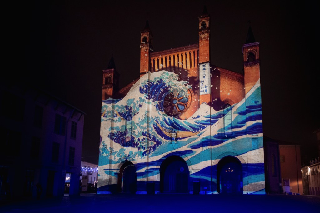 light mapping over the Saint Lawrence cathedral of Alba (Piedmont, Italy) with artistic paintings projected over the facade