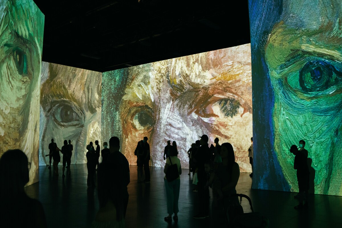 people at a projection mapping event of Vincent Van Gogh's art