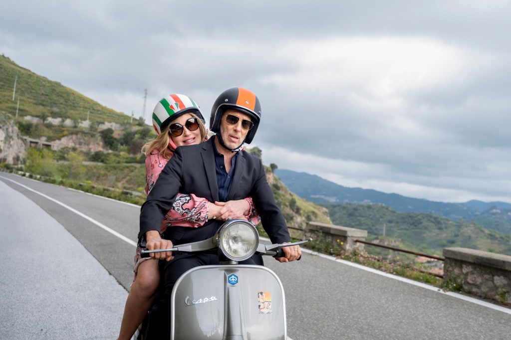 Jennifer Coolidge and Jon Gries of The White Lotus on a Vespa.