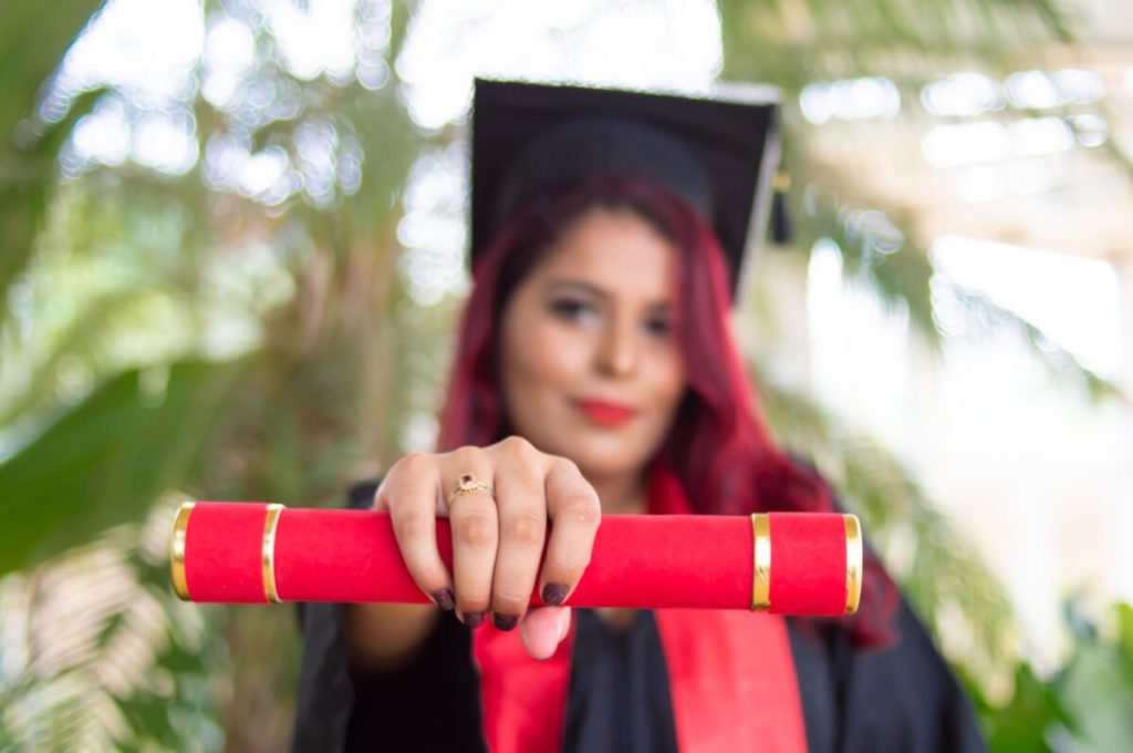 Graduate holding diploma