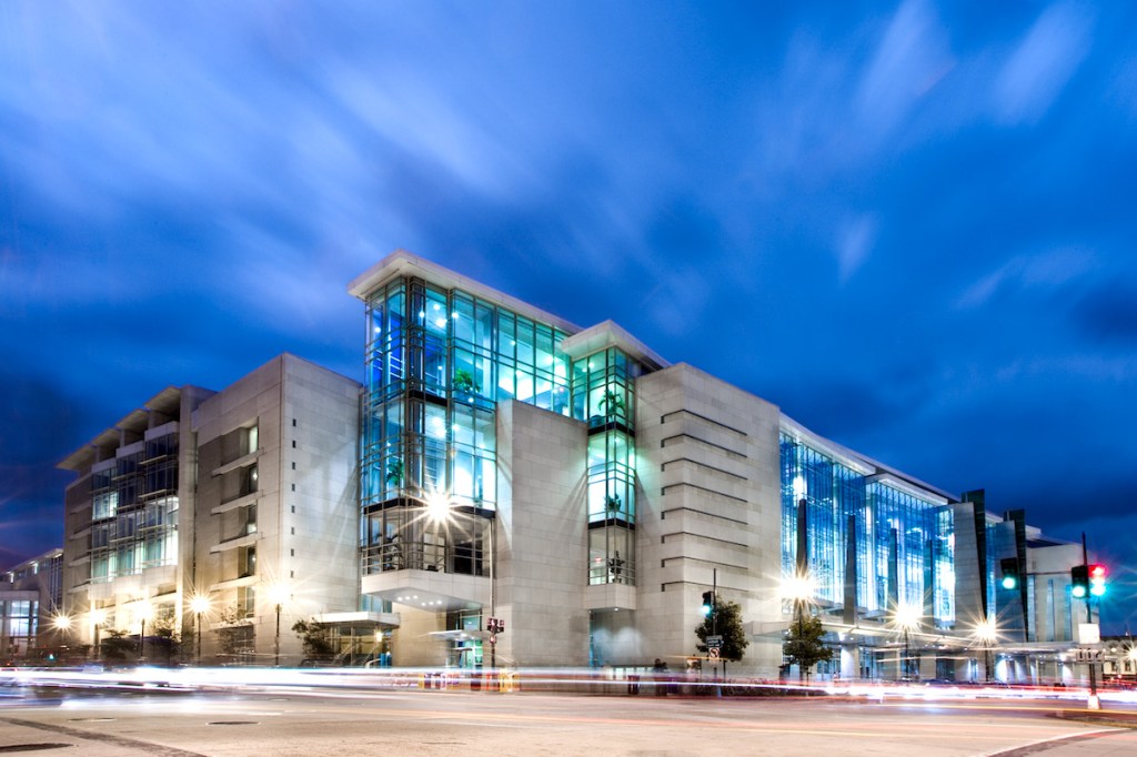 An exterior view of the Walter E. Washington Convention Center in Washington DC at dusk.