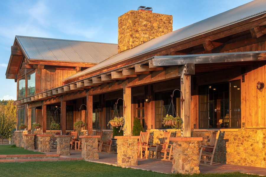 An exterior shot of Terra Farm + Manor, a rustic ranch-style building made of stone and wood beams, where attendees can enjoy the complete F&B experience through a farm-to-table tour.