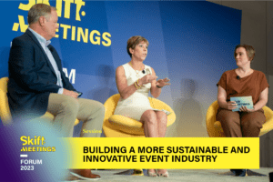 On stage shot of Tim Hemphill, Stephanie Turner, and Angela Tupper during a session presented by New Orleans & Company — Built to Host — as part of Skift Meetings Forum 2023. The lower-third caption reads, "Building a More Sustainable and Innovative Event Industry".