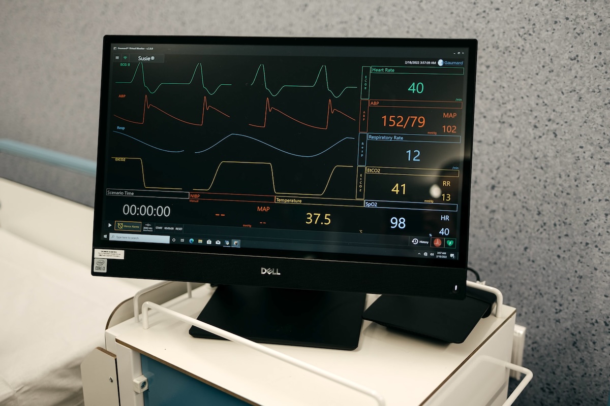 A patient monitor screen in a hospital room
