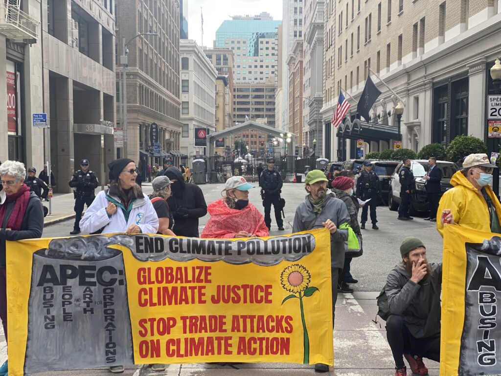 Climate change protesters formed a line on Market Street in front of a section of the APEC security zone barricade. 