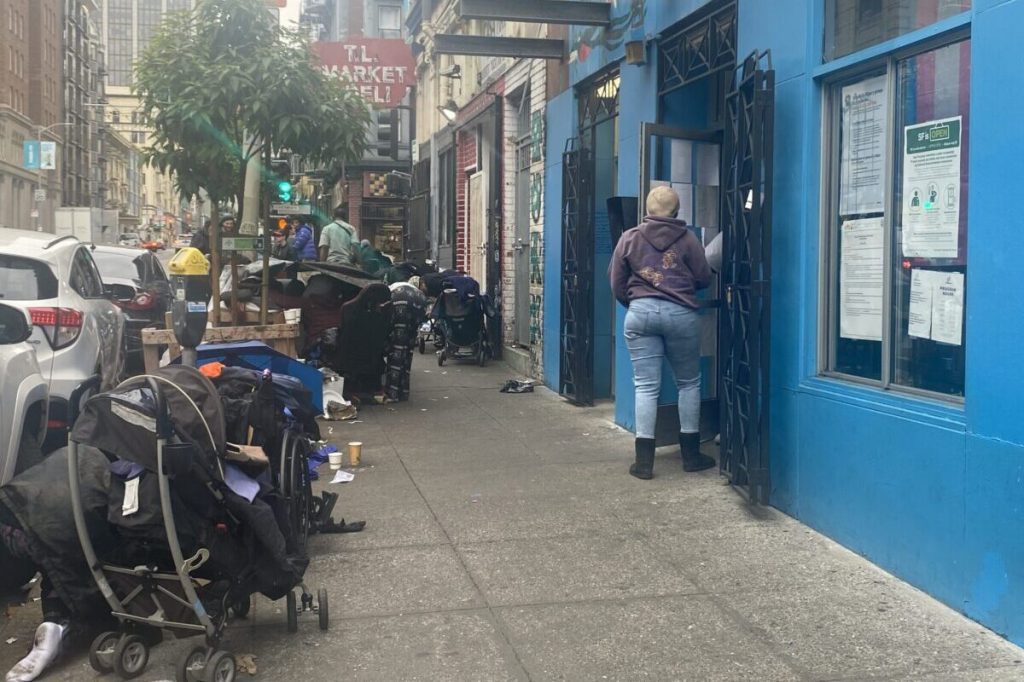 Unhoused area residents gather outside the Coalition on Homelessness in San Francisco, Ca.