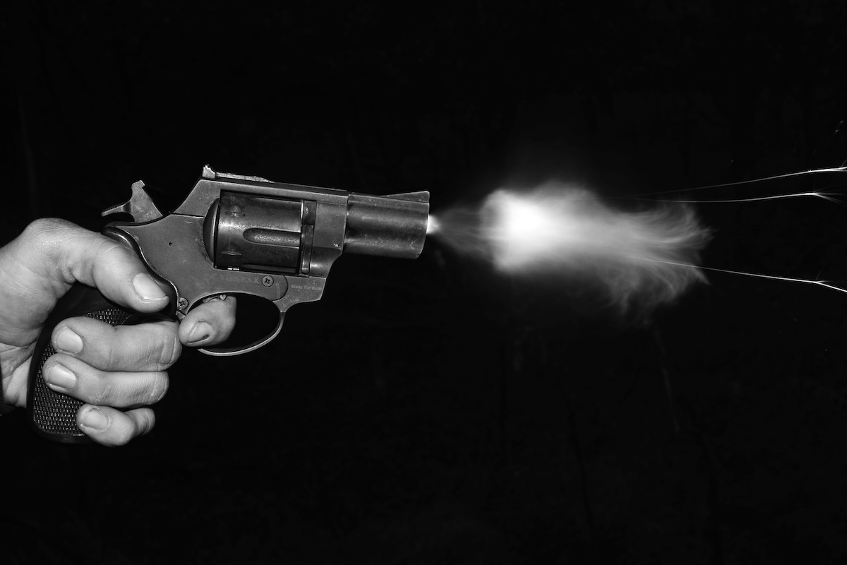 Shooting a revolver in front of a black surface