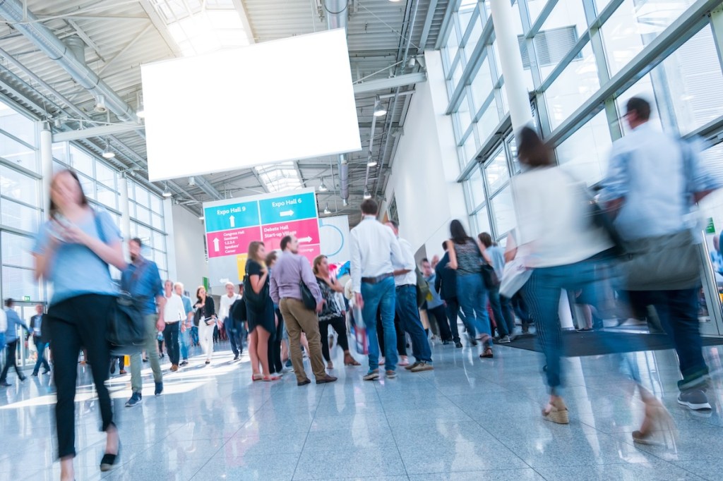 Crowd of people walking at a trade show