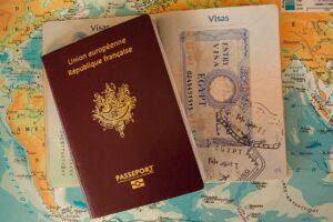 Passport and a visa laying on a world map