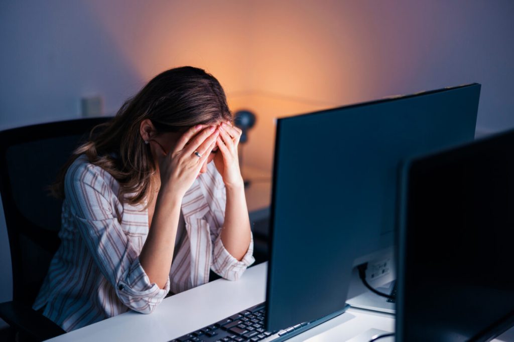 Stressed out woman sitting at computer.