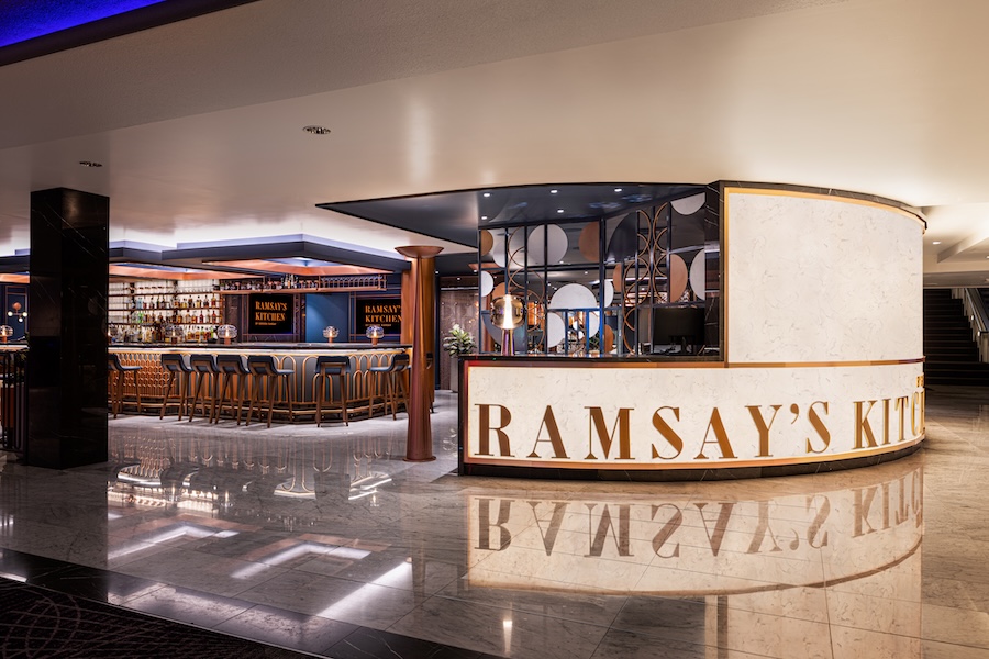 The front entrance of Ramsay's Kitchen at Harrah's Las Vegas, with highly polished marble floors and a stool bar visible just beyond the open-concept entrance.