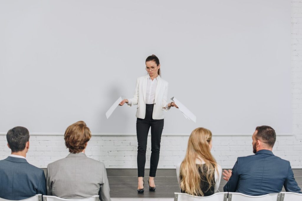 Woman on stage speaking.