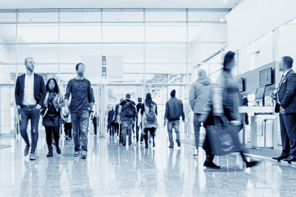 Crowd of business people walking in a modern hall at a trade show