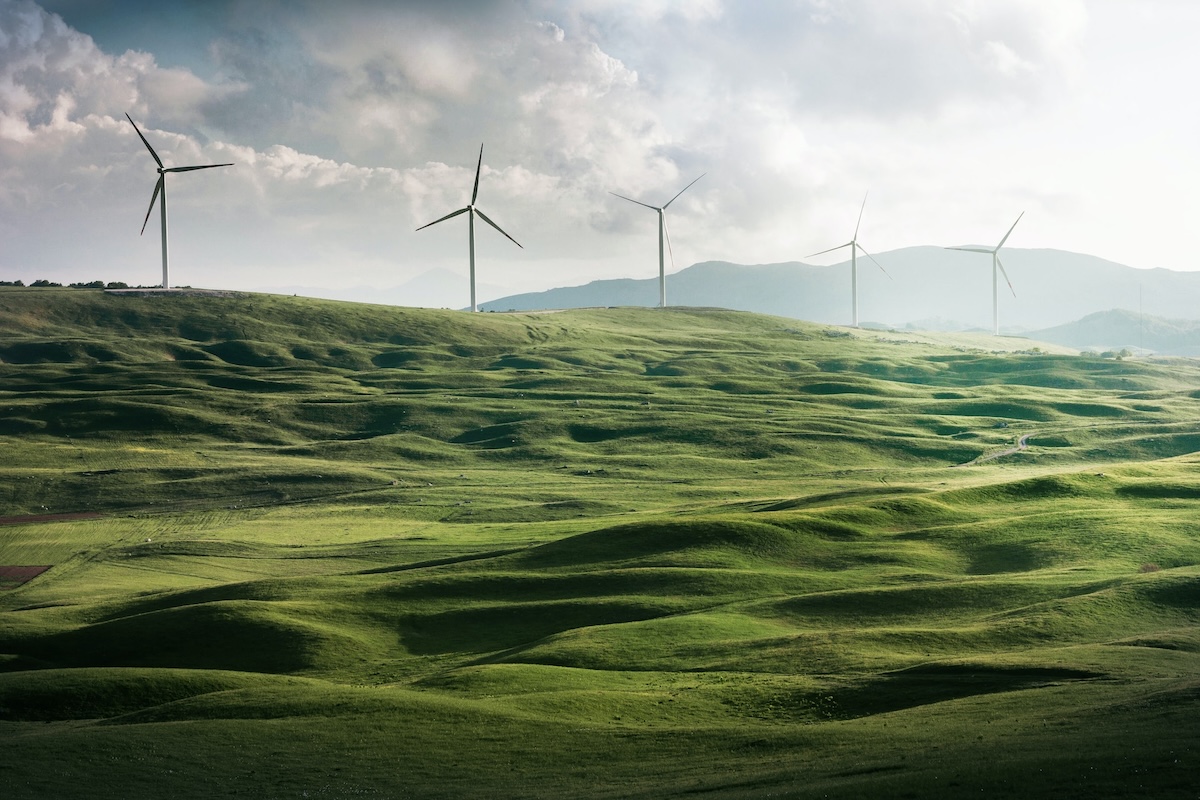 Wind turbine surrounded by a grassy valley