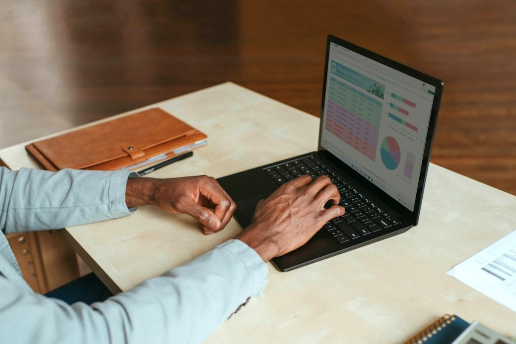 Hands of a man using a laptop