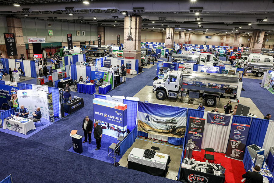 An aerial view of the show floor at the Easter Energy Expo 2023 (Atlantic City), with multiple booths visible alongside large trucks and construction vehicles on display.