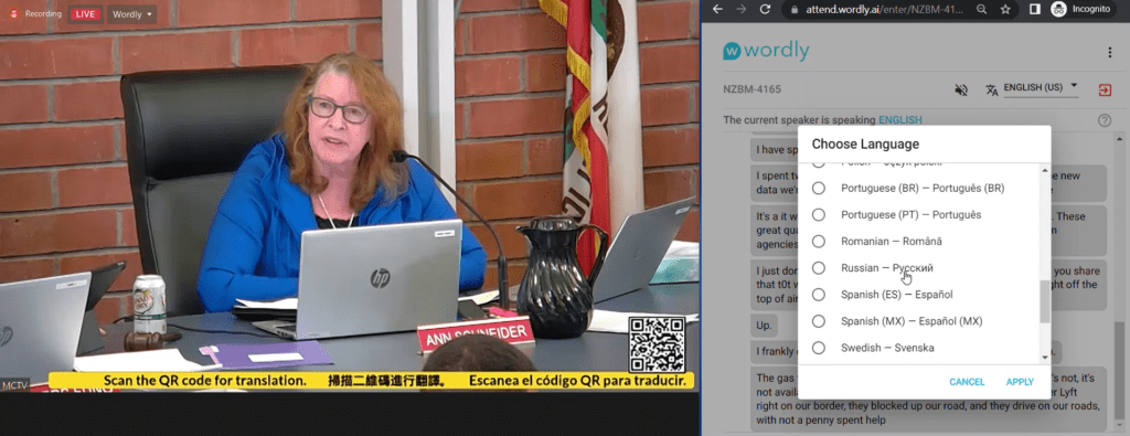 A split-screen image of a city council member speaking on one side, and the Wordly interface for selecting a language on the other. It also showcases a QR code for Wordly access in the lower third of the city council meeting live stream.