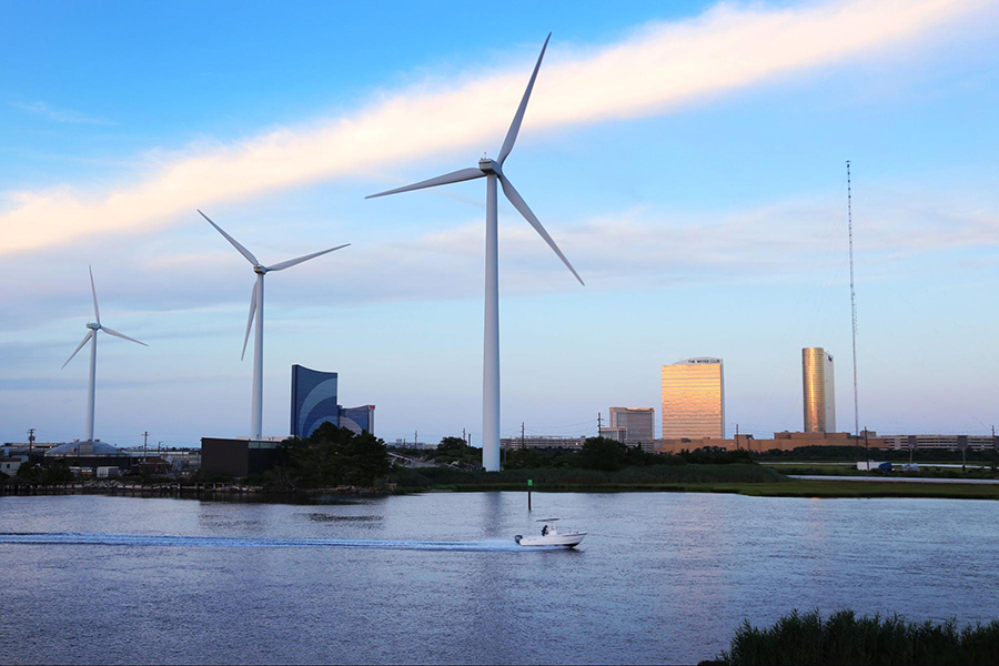 Three large windmills line the shore of Atlantic City.