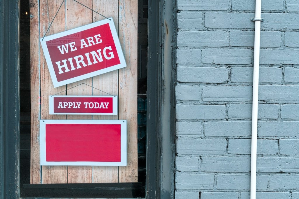 Hiring Sign Hanging on a Door