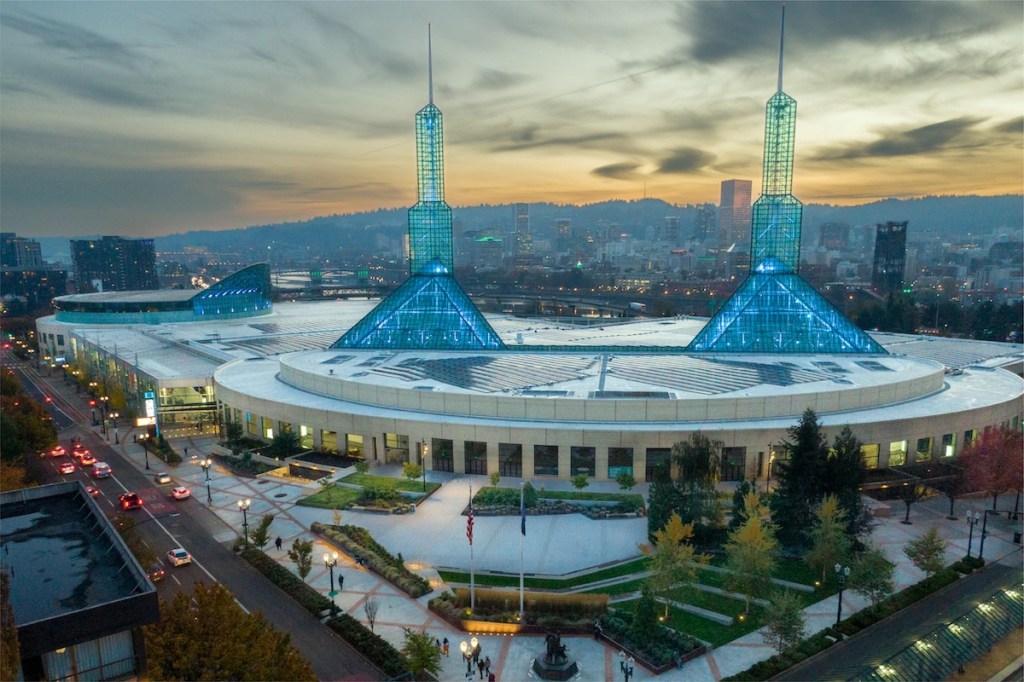 An aerial view of the Oregon Convention Center in Portland, with two pyramidal glass spires on the ceiling that can be lit up in different colors to match the event or conference theme.