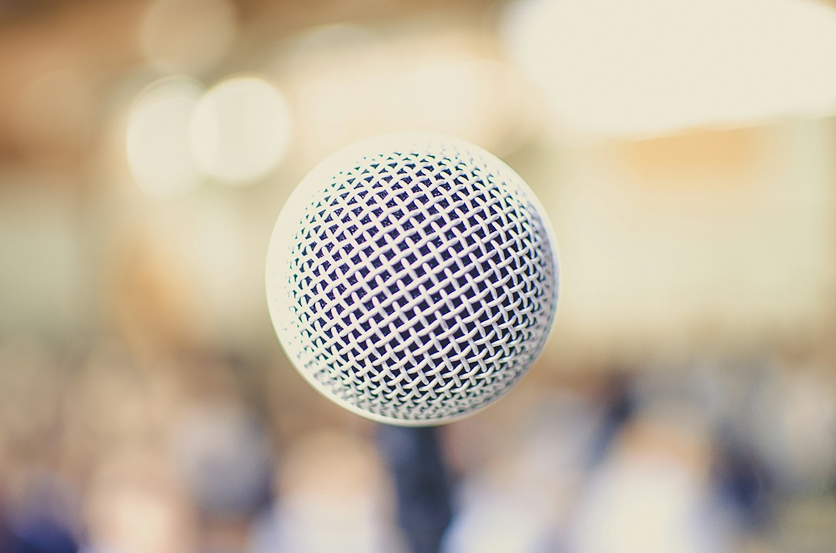 Close up photo of a microphone grill with blurred background
