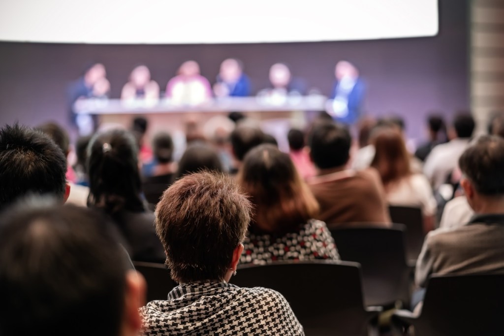 Rear view of Audience in the conference hall or seminar meeting which have Speakers are Brainstorming