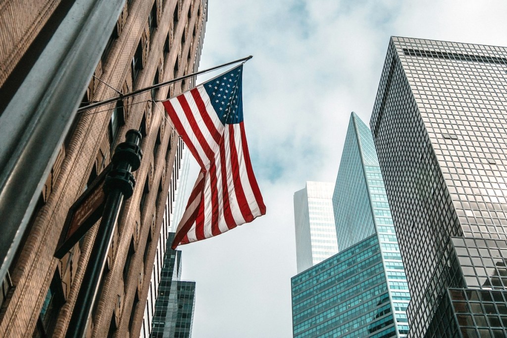 Big city skyscrapers with an America flag