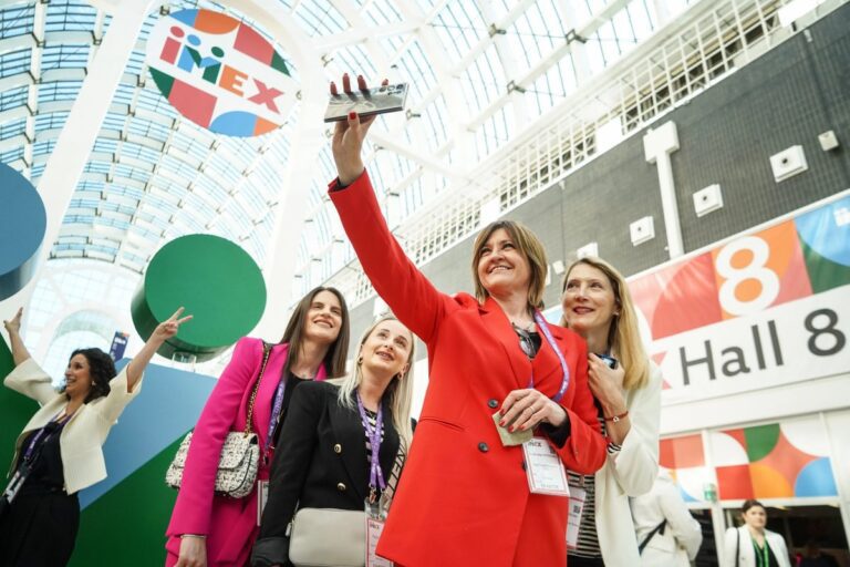 Participants taking a selfie at the entrance of the IMEX Frankfurt 2024 trade show