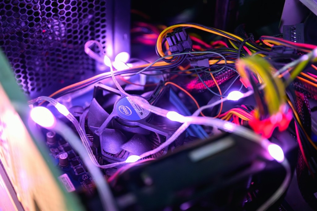 The inside of a computer case with led lights and wires