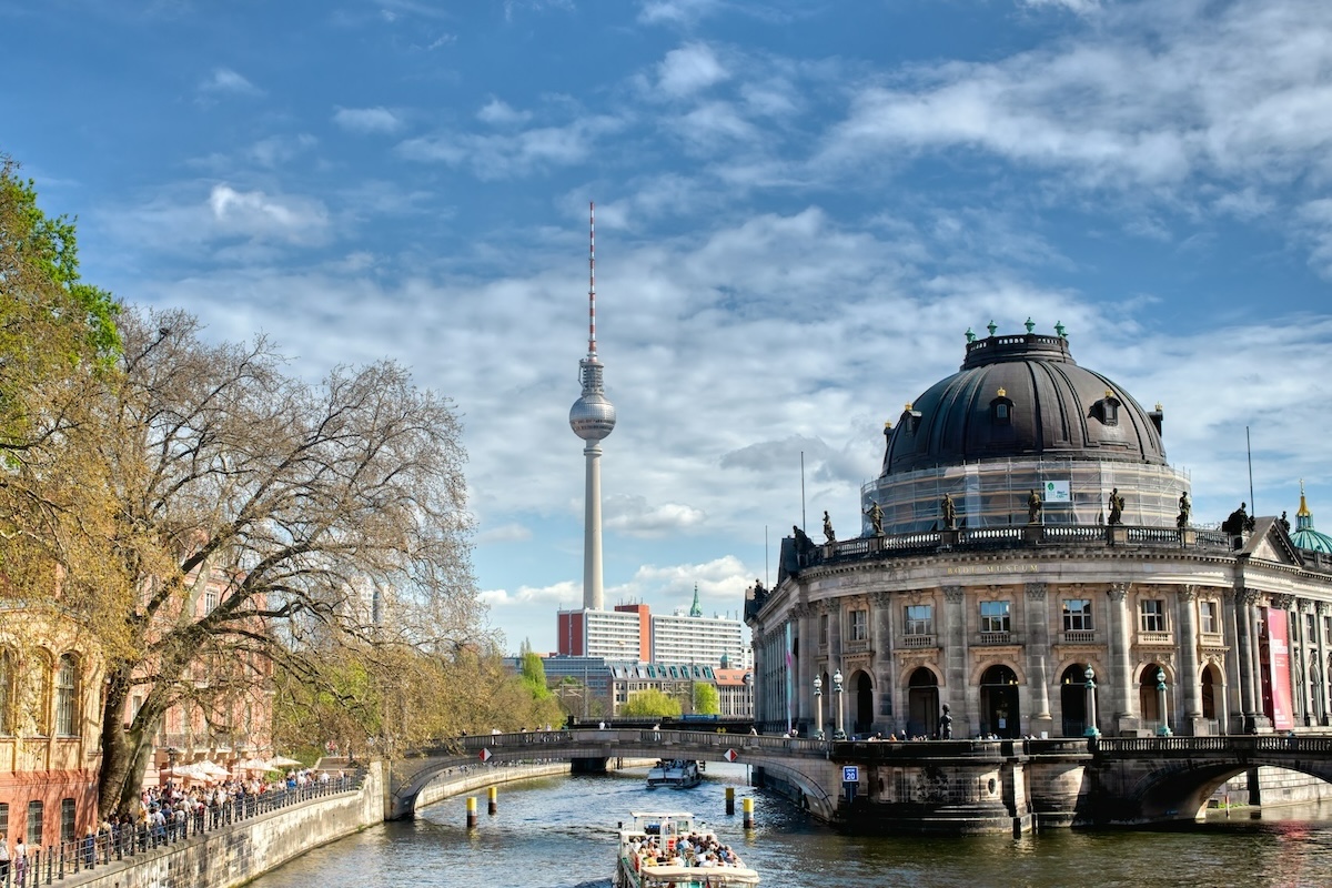 View of Berlin TV Tower from a historical part of the city with a canal and museum