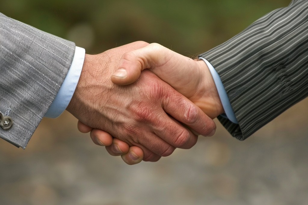 Closeup of the hands of two business men shaking hands after closing a deal