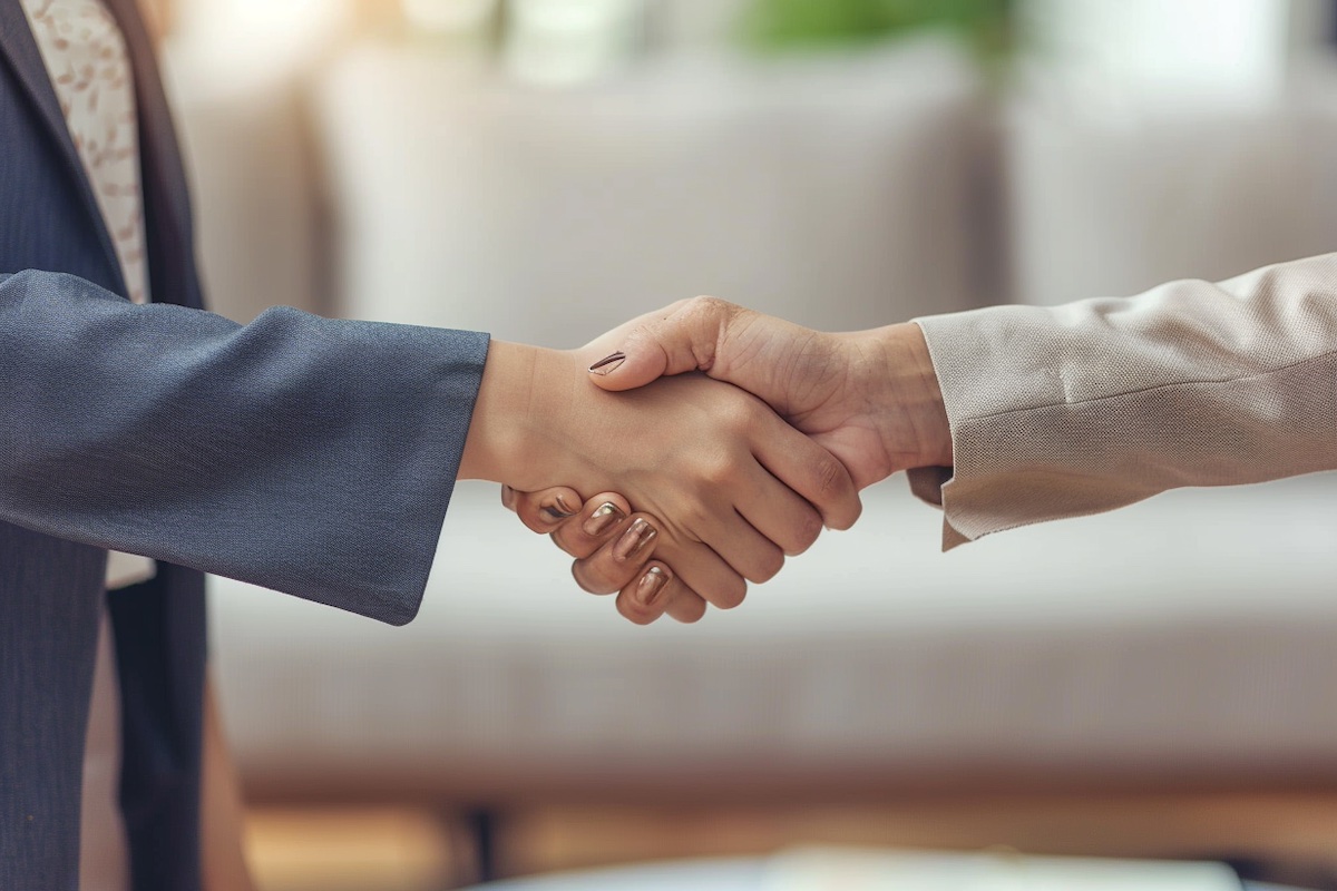 Closeup of the hands of two business women shaking hands after closing a deal