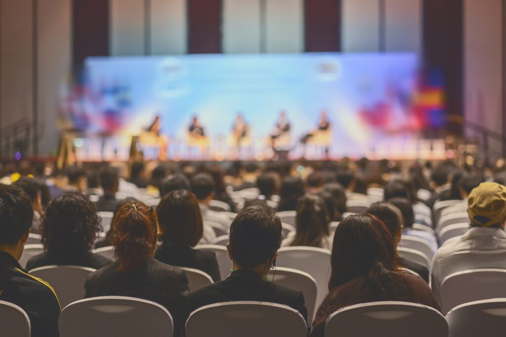 Audience facing the stage at a conference event