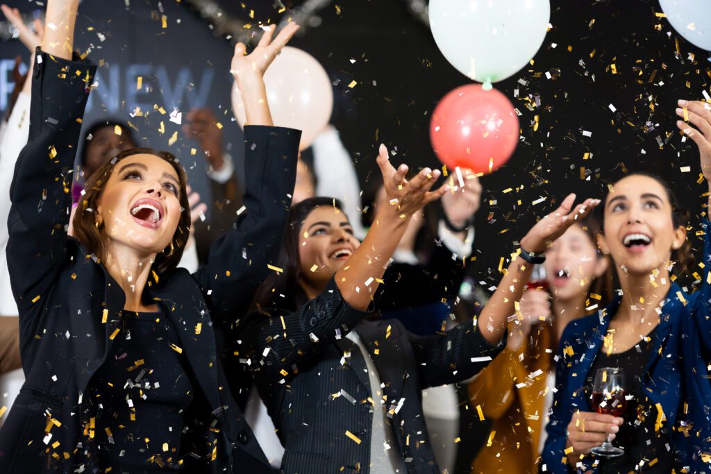 people playing with crowd props like balloon at a corporate event