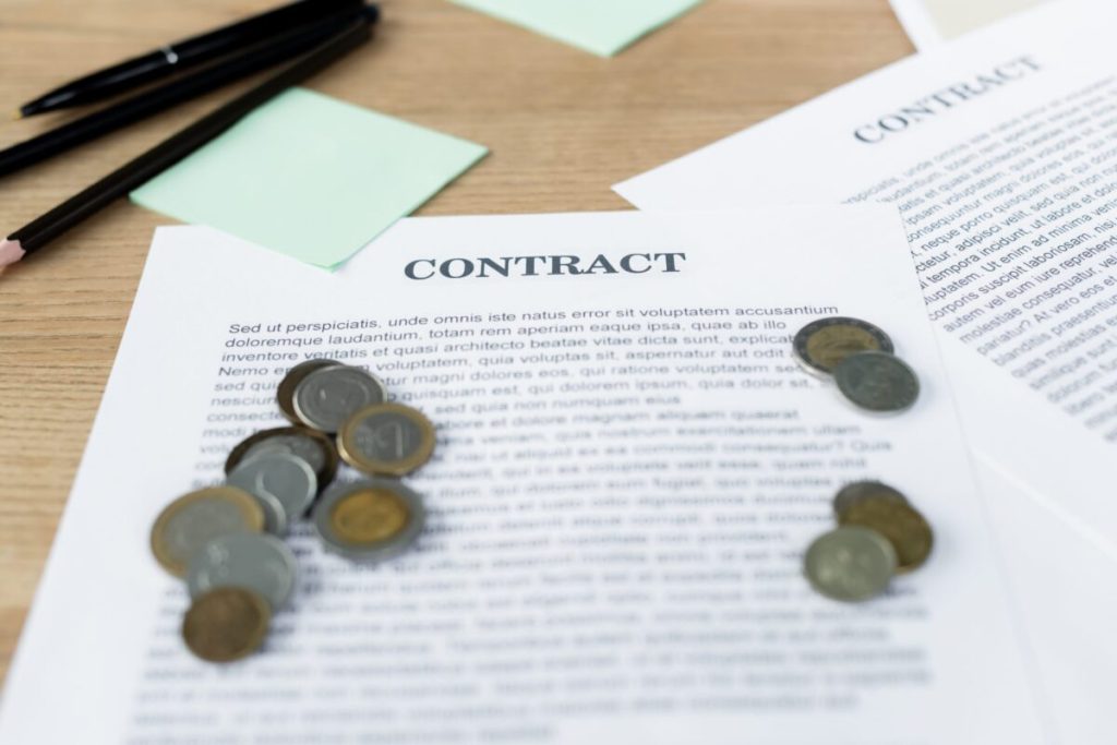 Coins stacked atop a contract