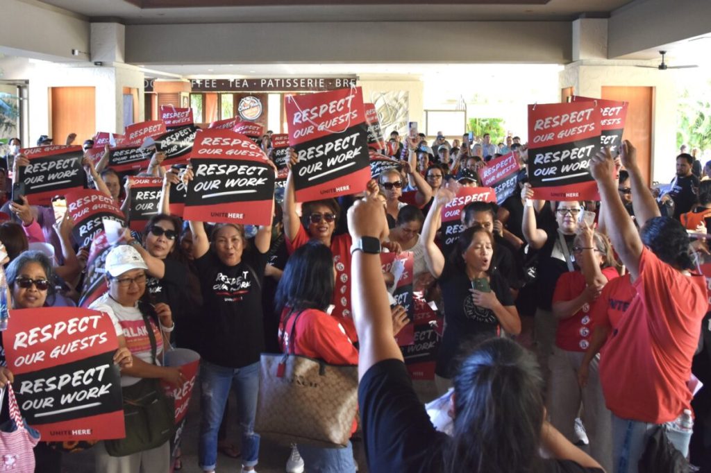 Hotel workers marching as part of a protest at a hotel strike.