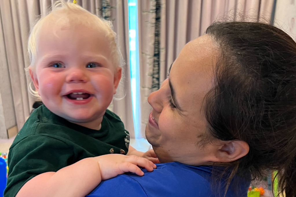 Childcare worker holding a baby