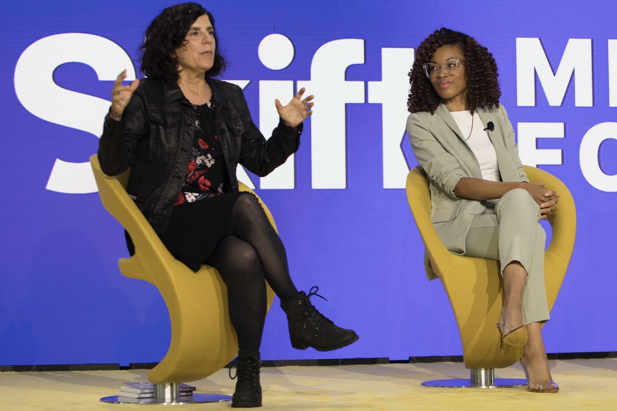 Two women on stage at a conference