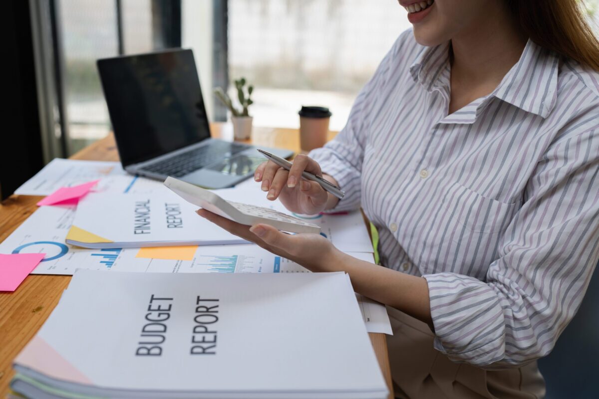 Businesswoman at a desk creating a budget.