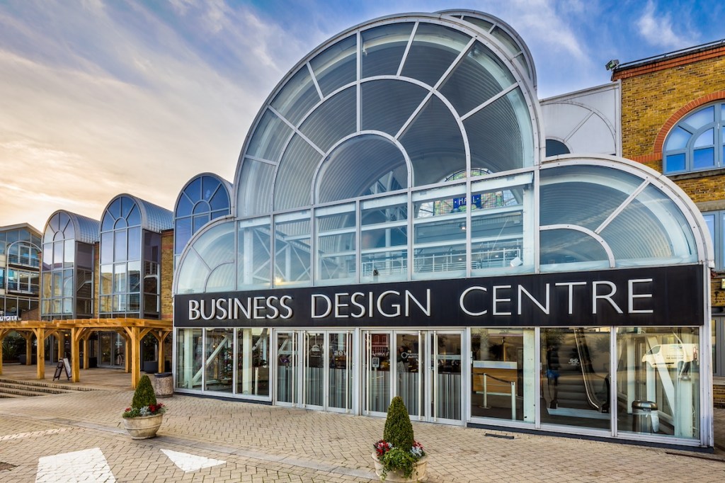 Facade of building featuring a curved class ceiling and entrance structure.