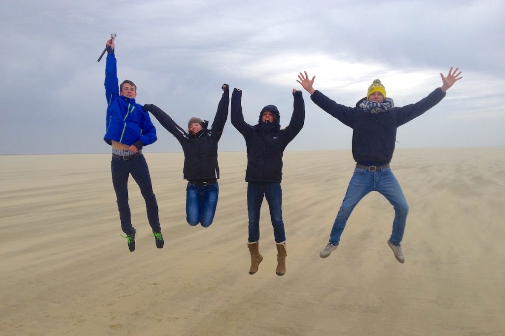 Group of people jumping for joy on a cold day