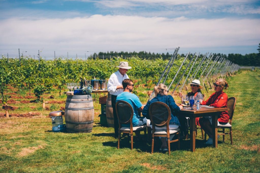 People sitting around a table in a winery