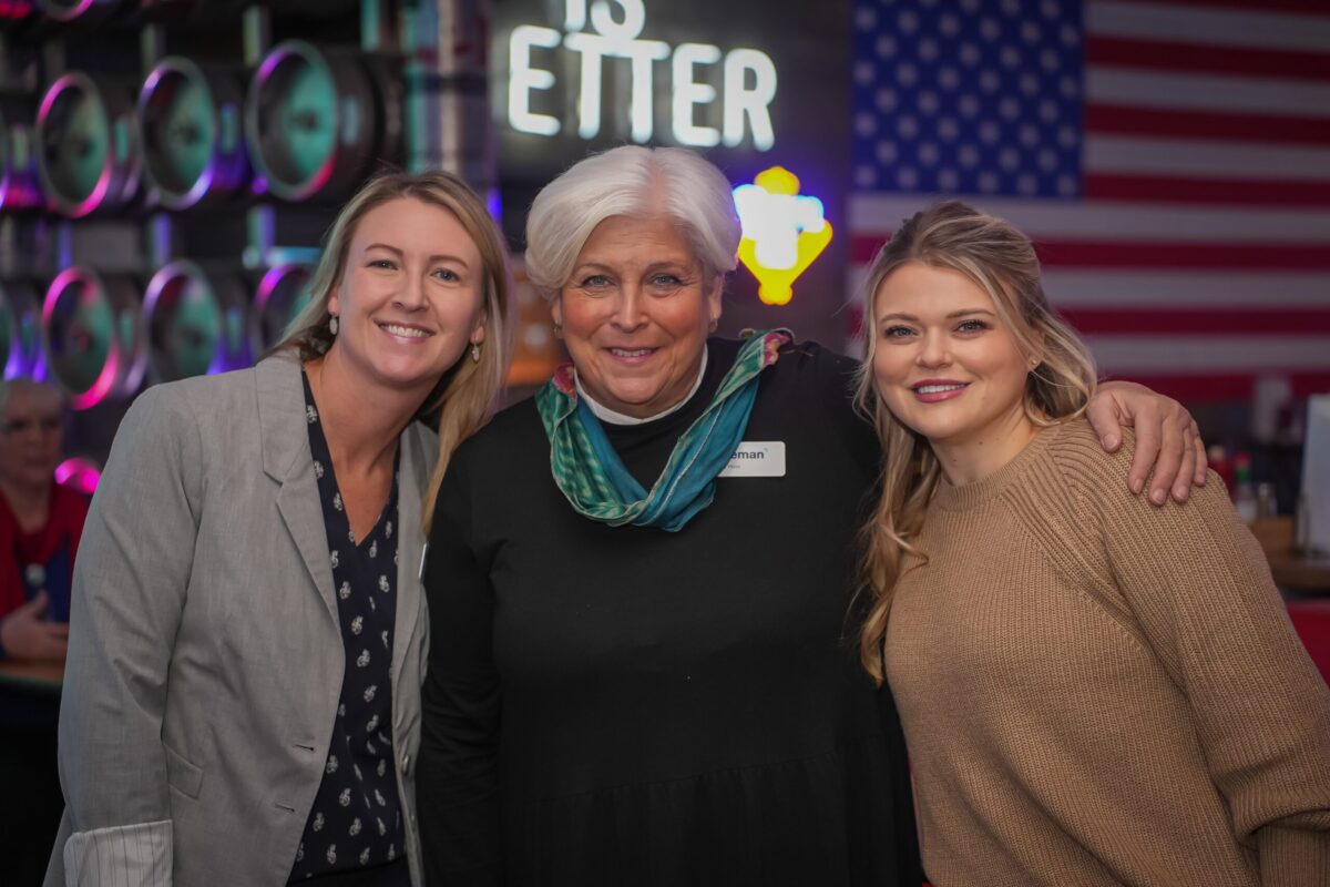 Women from three generations pose for photo