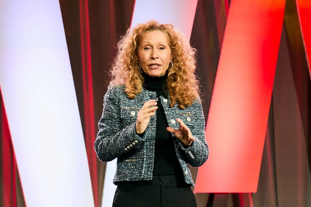 Female speaker talking from the stage at a conference