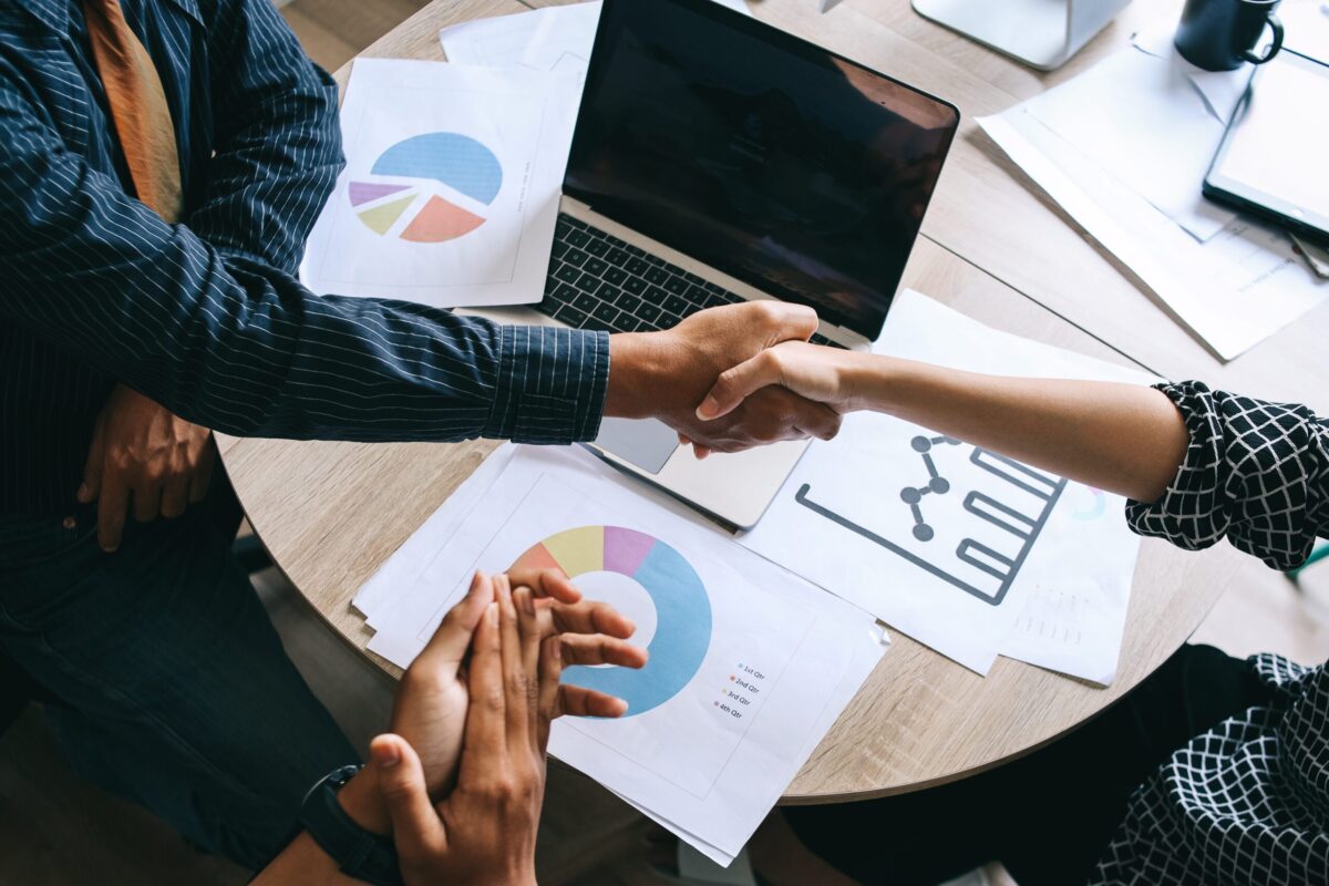 Shaking hands as part of a business deal illustrating Clarion buying a new company.