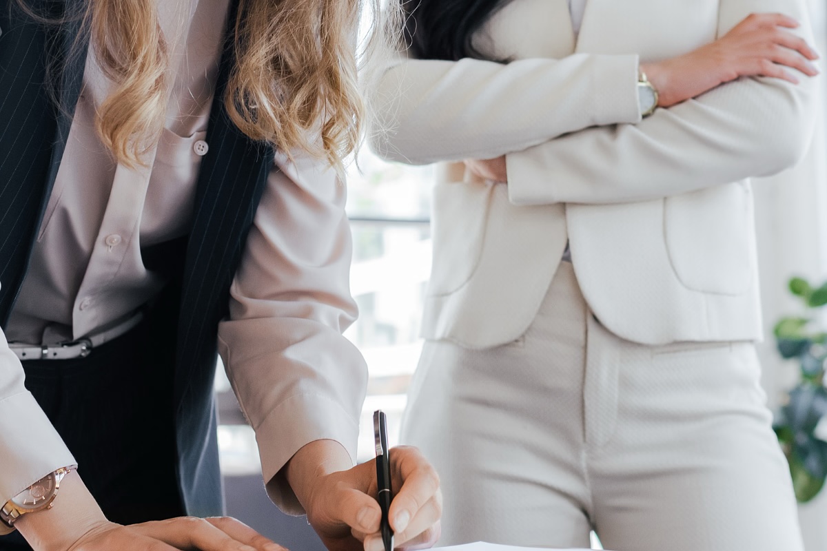 Two females signing a contract