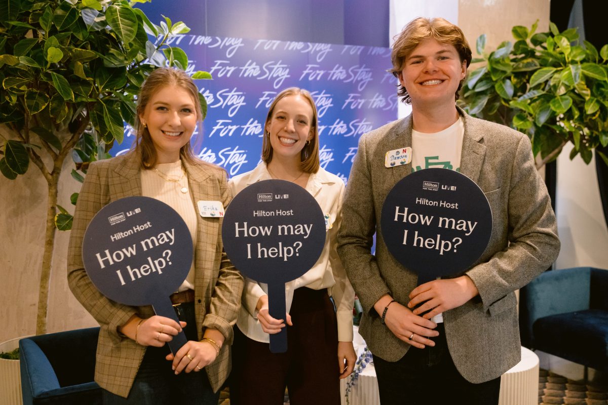 Meeting volunteers holding up help signs