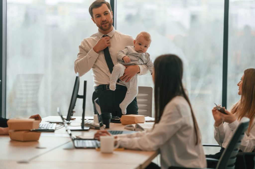 Man with baby at a conference.